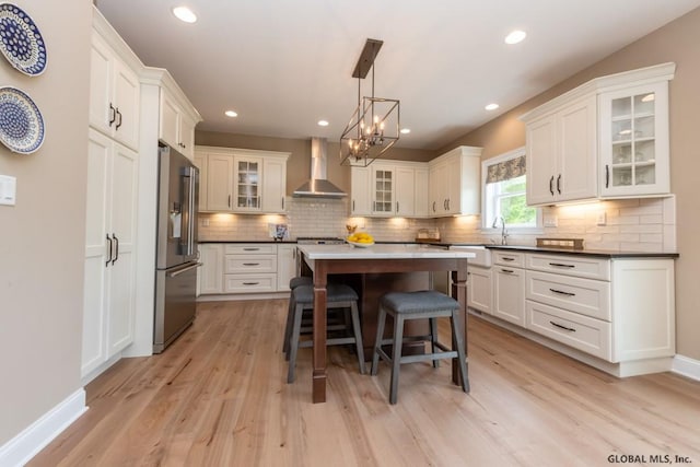 5 Hunter Ct, Milton, NY 12020 - kitchen featuring wall chimney range hood, stainless steel appliances, a breakfast bar area, light wood-style flooring, and recessed lighting