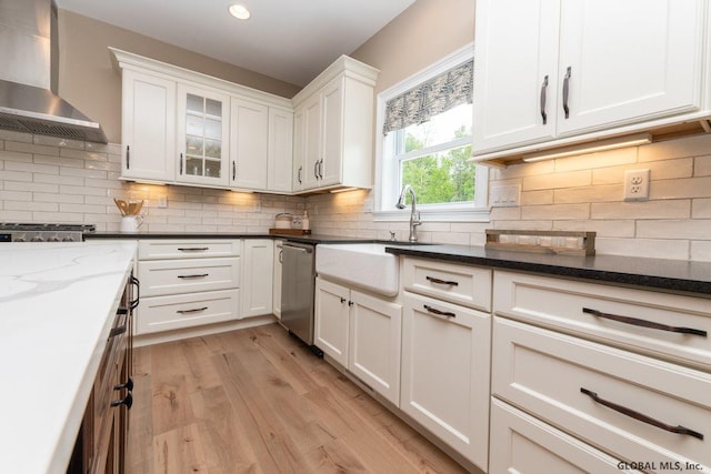 5 Hunter Ct, Milton, NY 12020 - kitchen featuring wall chimney exhaust hood, a sink, stainless steel dishwasher, white cabinets, and light wood-style flooring