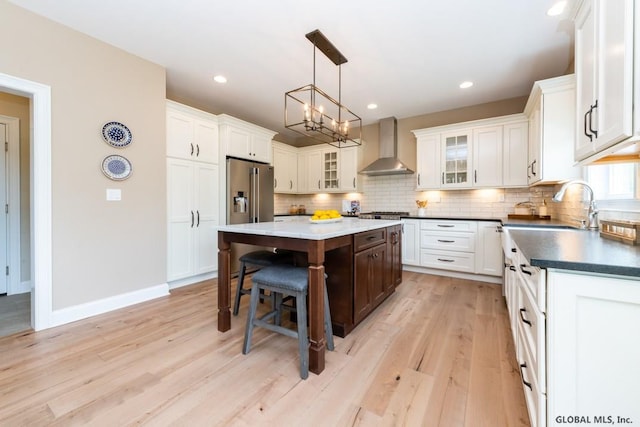 5 Hunter Ct, Milton, NY 12020 - kitchen with wall chimney range hood, high end fridge, a sink, a center island, and decorative backsplash