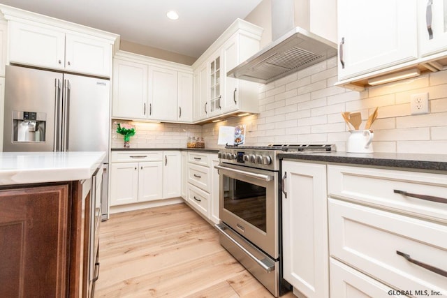 5 Hunter Ct, Milton, NY 12020 - kitchen featuring stainless steel appliances, wall chimney range hood, light wood finished floors, white cabinetry, and tasteful backsplash