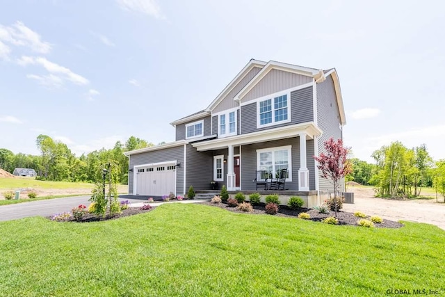 5 Hunter Ct, Milton, NY 12020 - craftsman-style home with covered porch, asphalt driveway, a front lawn, and a garage