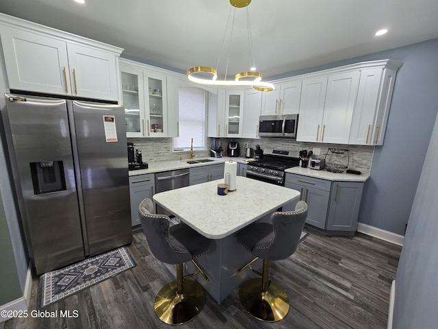 1117 Mcclellan St, Schenectady, NY 12309 - kitchen featuring stainless steel appliances, a sink, dark wood-type flooring, glass insert cabinets, and backsplash