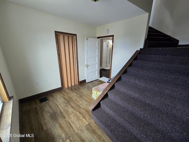1117 Mcclellan St, Schenectady, NY 12309 - staircase with wood finished floors and baseboards