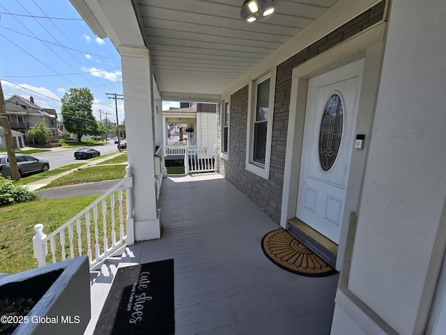 1117 Mcclellan St, Schenectady, NY 12309 - doorway to property featuring covered porch and stone siding