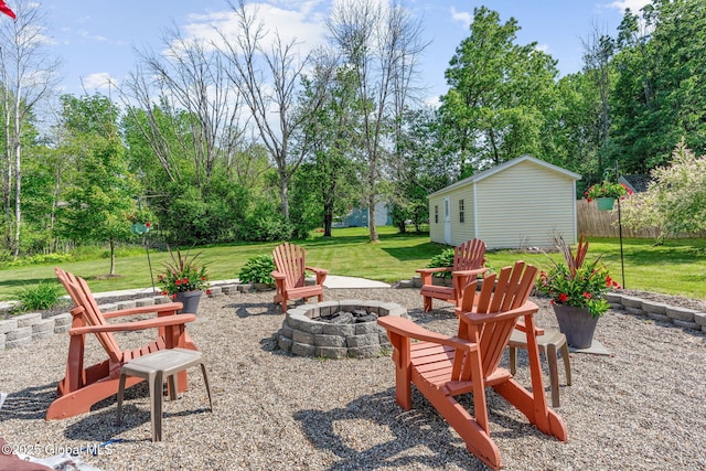 11 Lucille Ln, Malta, NY 12019 - view of patio / terrace with a fire pit, an outbuilding, and view of wooded area