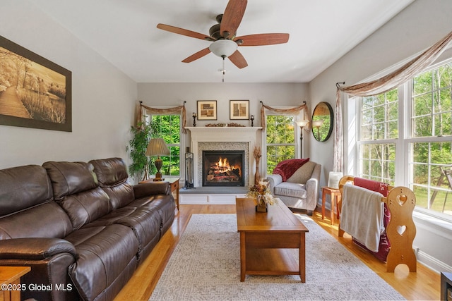 11 Lucille Ln, Malta, NY 12019 - living area featuring light wood-type flooring, a lit fireplace, and ceiling fan