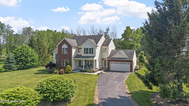 11 Lucille Ln, Malta, NY 12019 - traditional home featuring asphalt driveway, a garage, and a front yard