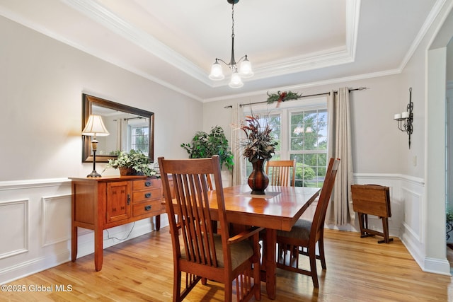 11 Lucille Ln, Malta, NY 12019 - dining space with plenty of natural light, light wood-type flooring, a chandelier, a decorative wall, and a wainscoted wall