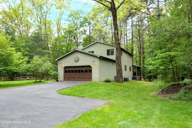 124 Edie Rd, Wilton, NY 12866 - view of home's exterior featuring asphalt driveway, a chimney, a yard, and a garage