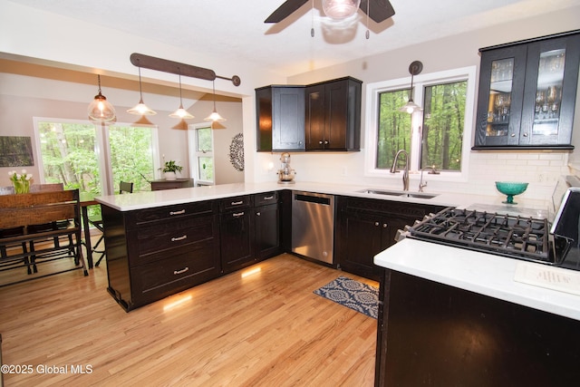 124 Edie Rd, Wilton, NY 12866 - kitchen with stainless steel dishwasher, a peninsula, light wood-style flooring, a ceiling fan, and light countertops