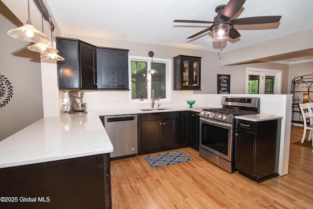 124 Edie Rd, Wilton, NY 12866 - kitchen featuring stainless steel appliances, a peninsula, healthy amount of natural light, and decorative backsplash