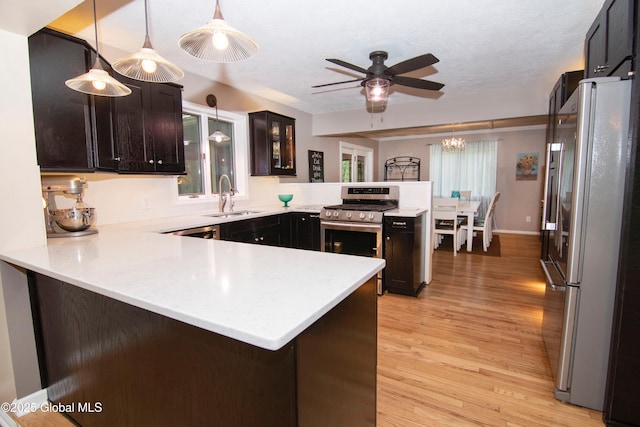 124 Edie Rd, Wilton, NY 12866 - kitchen featuring stainless steel appliances, a peninsula, light countertops, and light wood-type flooring