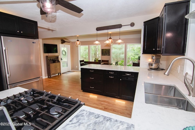 124 Edie Rd, Wilton, NY 12866 - kitchen with high end refrigerator, dark cabinetry, light wood finished floors, a peninsula, and a ceiling fan