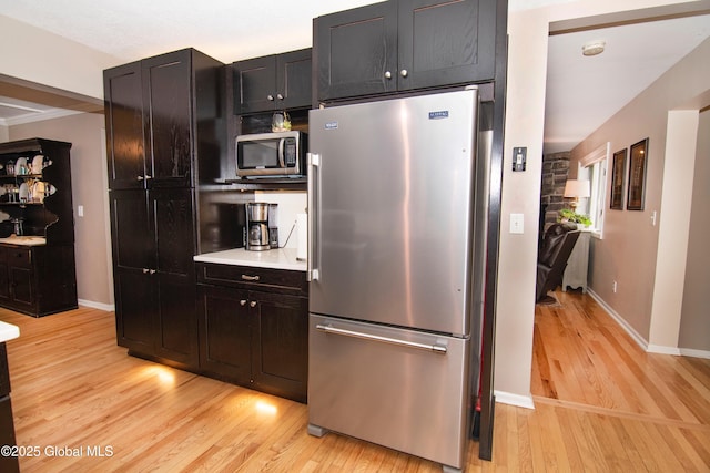 124 Edie Rd, Wilton, NY 12866 - kitchen featuring appliances with stainless steel finishes, light wood-type flooring, light countertops, and dark cabinets