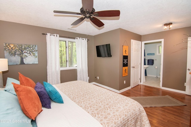124 Edie Rd, Wilton, NY 12866 - bedroom featuring wood finished floors, a textured ceiling, ensuite bath, and ceiling fan