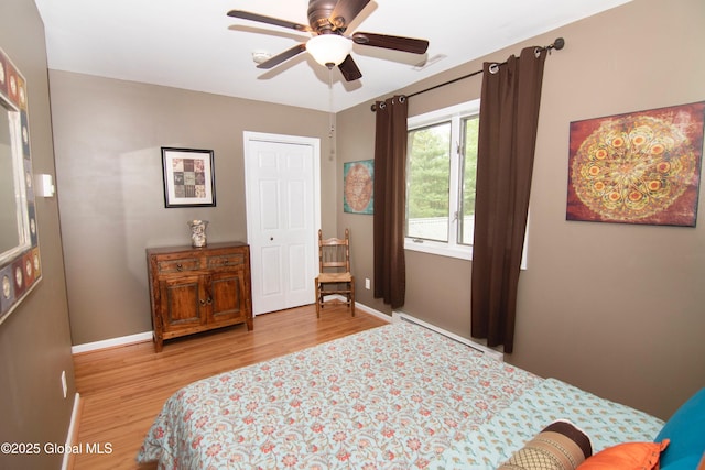 124 Edie Rd, Wilton, NY 12866 - bedroom with light wood-style floors, baseboard heating, and a ceiling fan