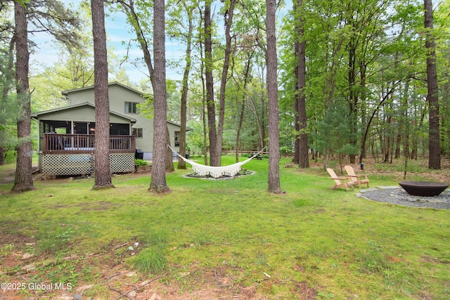 124 Edie Rd, Wilton, NY 12866 - view of grassy yard featuring an outdoor fire pit and a sunroom