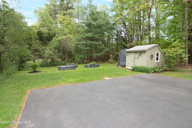 124 Edie Rd, Wilton, NY 12866 - view of green lawn featuring a storage shed and a vegetable garden
