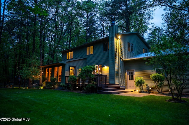 124 Edie Rd, Wilton, NY 12866 - back of house featuring a yard, a wooden deck, and a chimney