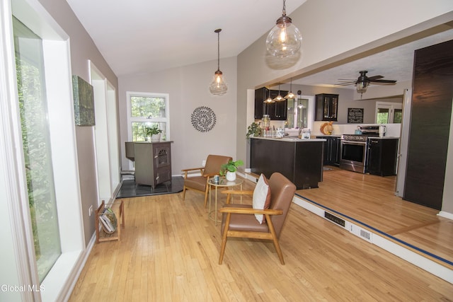 124 Edie Rd, Wilton, NY 12866 - dining room featuring vaulted ceiling, light wood finished floors, a wood stove, and ceiling fan