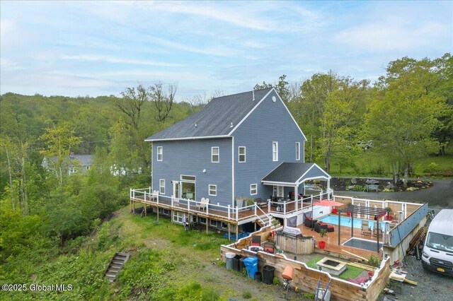 14 Calvin Cole Rd, Stephentown, NY 12169 - back of house with a wooden deck, a wooded view, and an outdoor pool