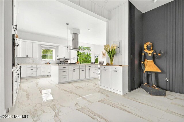 14 Calvin Cole Rd, Stephentown, NY 12169 - kitchen with light marble finish floors, white cabinetry, wall oven, hanging light fixtures, and a kitchen island
