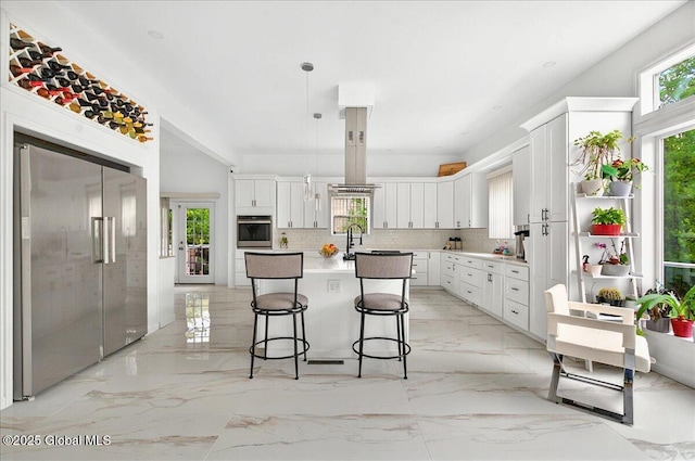 14 Calvin Cole Rd, Stephentown, NY 12169 - kitchen with appliances with stainless steel finishes, light marble finish flooring, a breakfast bar, and white cabinets