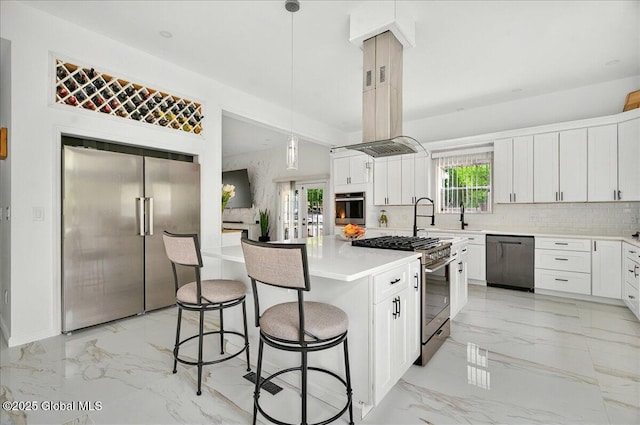 14 Calvin Cole Rd, Stephentown, NY 12169 - kitchen with stainless steel appliances, light marble finish flooring, a breakfast bar area, a kitchen island, and white cabinets