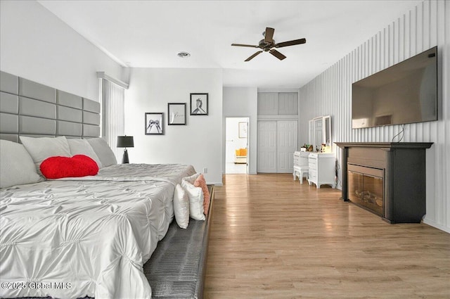 14 Calvin Cole Rd, Stephentown, NY 12169 - bedroom with a glass covered fireplace, light wood finished floors, and a ceiling fan