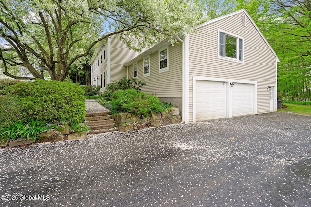 9 Longwood Dr, Saratoga Springs, Inside, NY 12866 - view of side of home with an attached garage and driveway