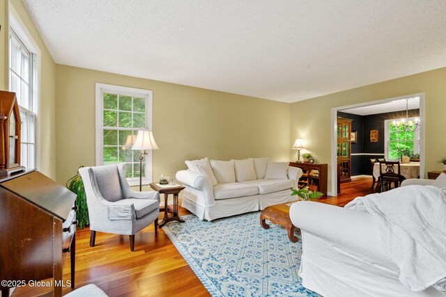 9 Longwood Dr, Saratoga Springs, Inside, NY 12866 - living room with wood finished floors, a chandelier, and healthy amount of natural light
