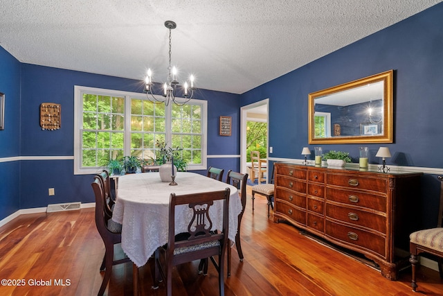 9 Longwood Dr, Saratoga Springs, Inside, NY 12866 - dining room featuring a chandelier, wood finished floors, and a textured ceiling