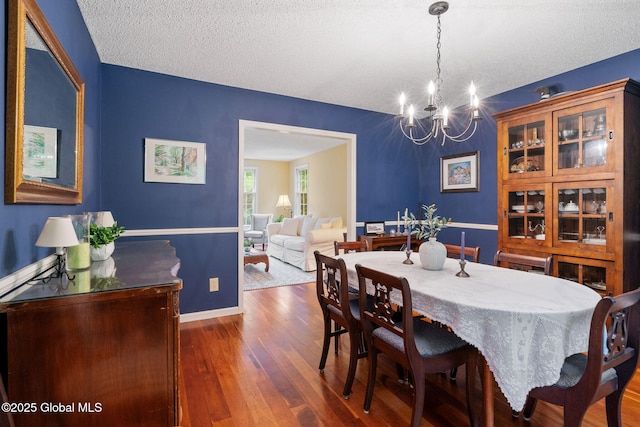 9 Longwood Dr, Saratoga Springs, Inside, NY 12866 - dining space featuring a chandelier, wood finished floors, and a textured ceiling