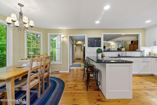 9 Longwood Dr, Saratoga Springs, Inside, NY 12866 - kitchen featuring white cabinets, tasteful backsplash, light wood-style flooring, and recessed lighting