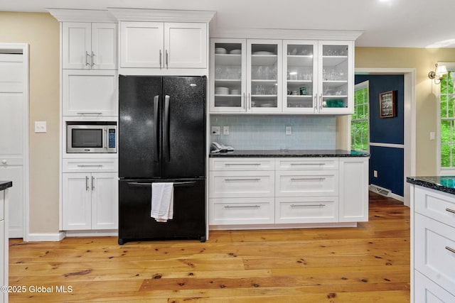 9 Longwood Dr, Saratoga Springs, Inside, NY 12866 - kitchen featuring freestanding refrigerator, stainless steel microwave, white cabinetry, backsplash, and light wood-style flooring