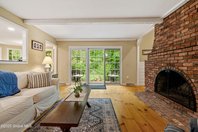 9 Longwood Dr, Saratoga Springs, Inside, NY 12866 - living area with beam ceiling, healthy amount of natural light, hardwood / wood-style flooring, and a brick fireplace