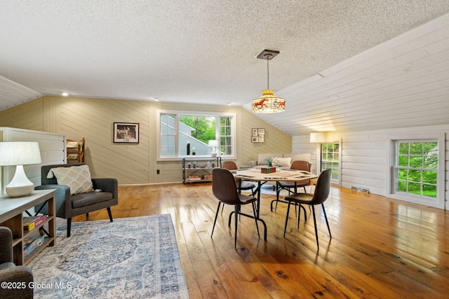 9 Longwood Dr, Saratoga Springs, Inside, NY 12866 - dining space with wood-type flooring, lofted ceiling, a textured ceiling, and wooden walls