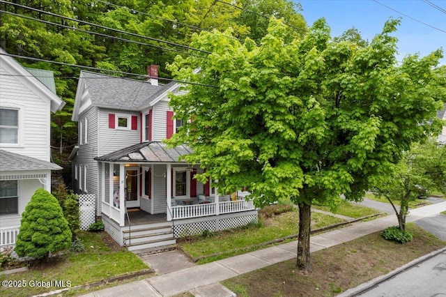32 Main St, Lake Luzerne, NY 12846 - view of front of house featuring a porch, a chimney, and a shingled roof