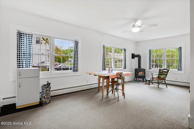 32 Main St, Lake Luzerne, NY 12846 - dining space featuring a wood stove and ceiling fan