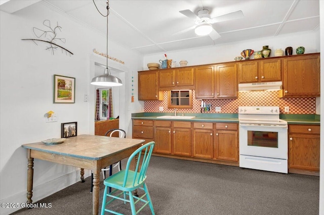 32 Main St, Lake Luzerne, NY 12846 - kitchen featuring electric stove, under cabinet range hood, brown cabinetry, decorative backsplash, and ornamental molding