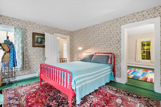 32 Main St, Lake Luzerne, NY 12846 - bedroom featuring multiple windows, baseboard heating, baseboards, wallpapered walls, and wood finished floors