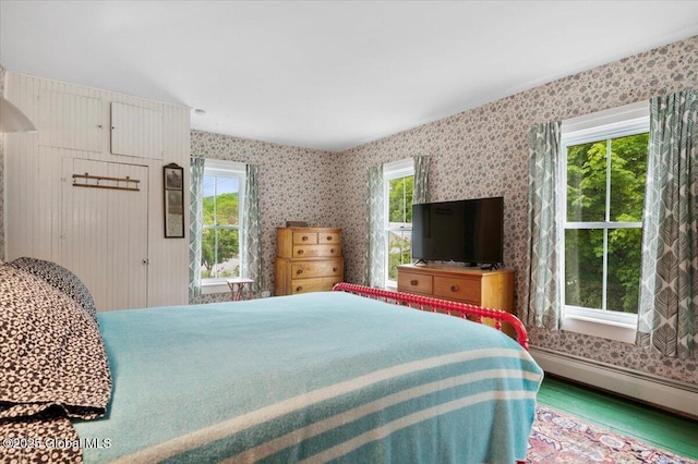 32 Main St, Lake Luzerne, NY 12846 - bedroom with multiple windows, a baseboard radiator, wallpapered walls, and wood finished floors