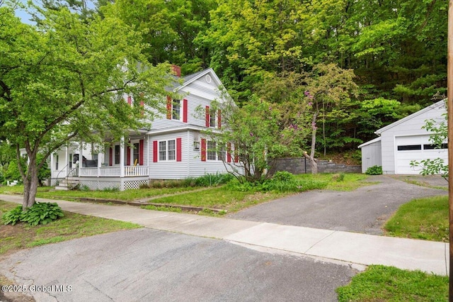 32 Main St, Lake Luzerne, NY 12846 - view of front of house featuring a porch, asphalt driveway, and an outdoor structure