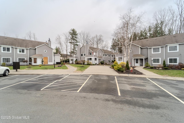 1976 Curry Rd Unit E-136, Schenectady, NY 12303 - uncovered parking lot featuring a residential view