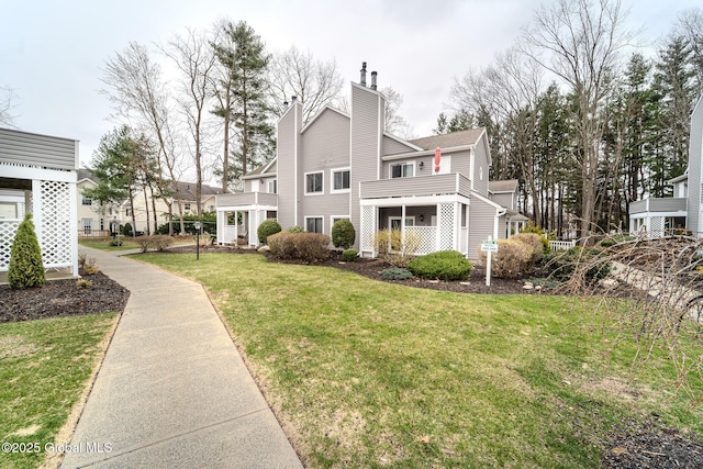 1976 Curry Rd Unit E-136, Schenectady, NY 12303 - view of home's exterior featuring a lawn and a chimney