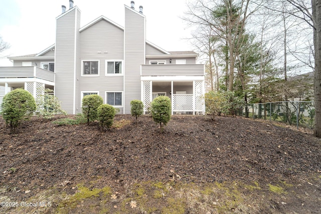 1976 Curry Rd Unit E-136, Schenectady, NY 12303 - back of house with a chimney and a balcony