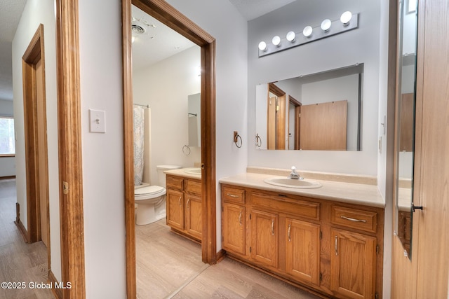 1976 Curry Rd Unit E-136, Schenectady, NY 12303 - full bath featuring wood finished floors, vanity, and toilet