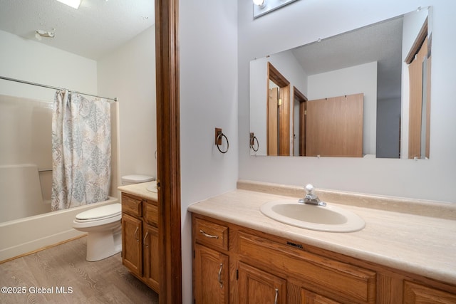 1976 Curry Rd Unit E-136, Schenectady, NY 12303 - full bathroom featuring vanity, toilet, wood finished floors, and shower / tub combo with curtain