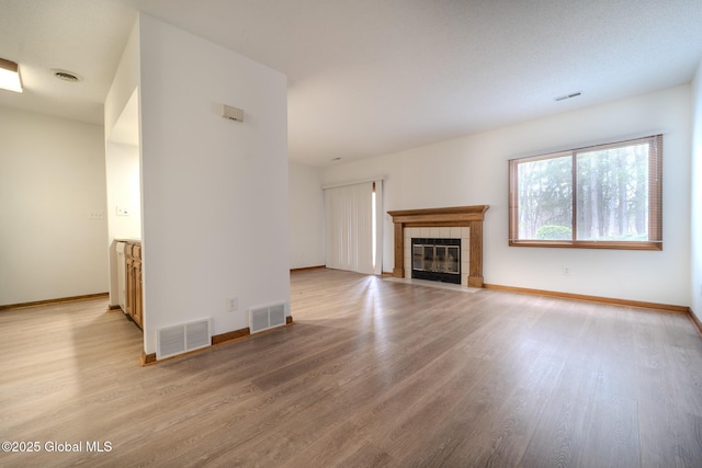 1976 Curry Rd Unit E-136, Schenectady, NY 12303 - unfurnished living room featuring light wood-style floors, a fireplace, and baseboards