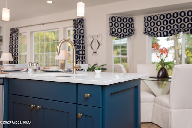 12 Anson Ct, Malta, NY 12020 - kitchen with a sink, blue cabinets, hanging light fixtures, light countertops, and recessed lighting